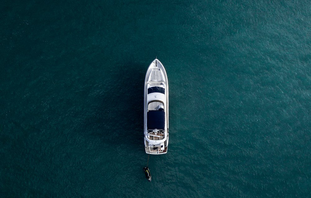 Aerial view of a white yacht on calm water