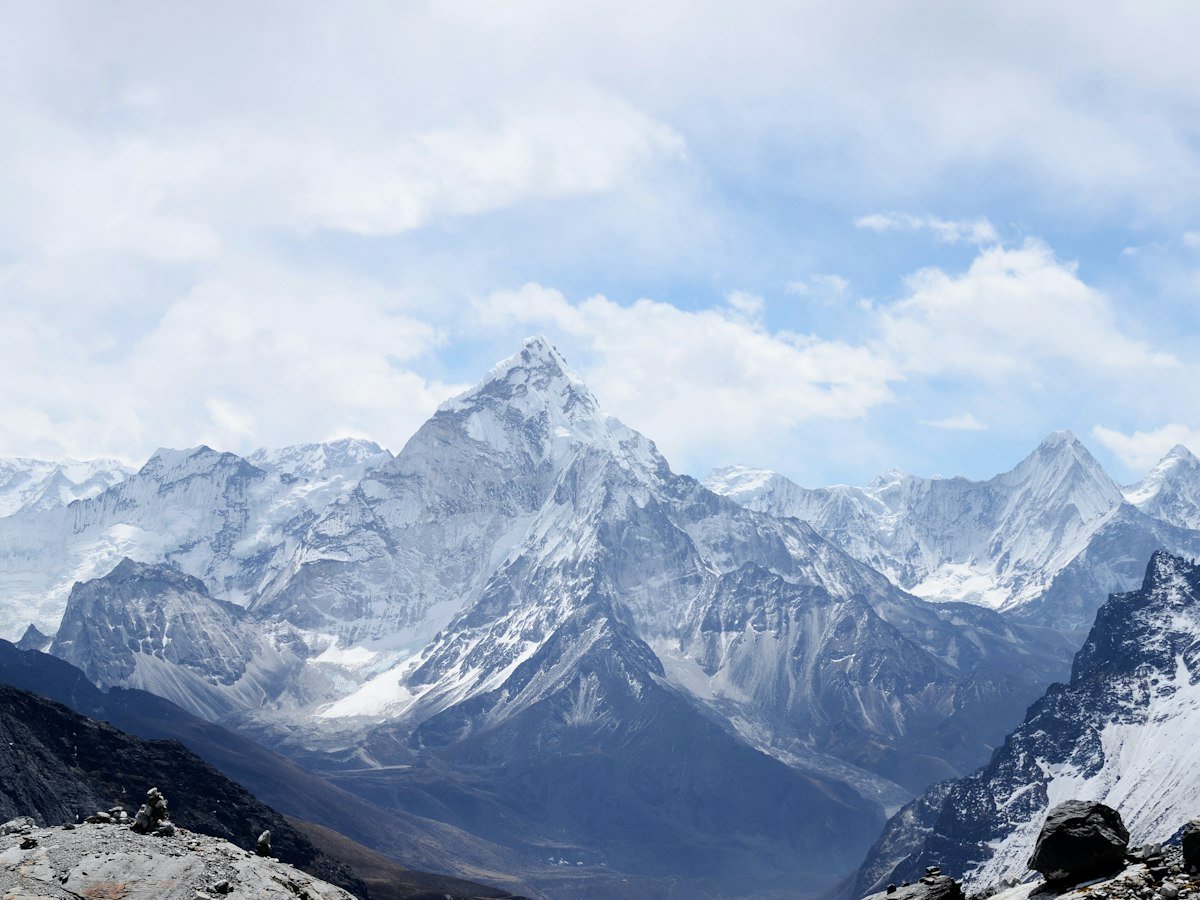 Snow-covered peak of Ama Dablam rising above a mountain valley