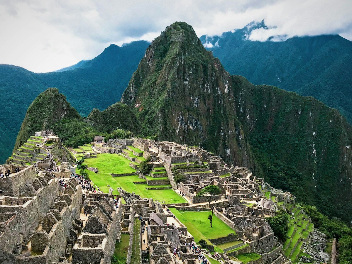Ancient stone ruins of Machu Picchu among green peaks
