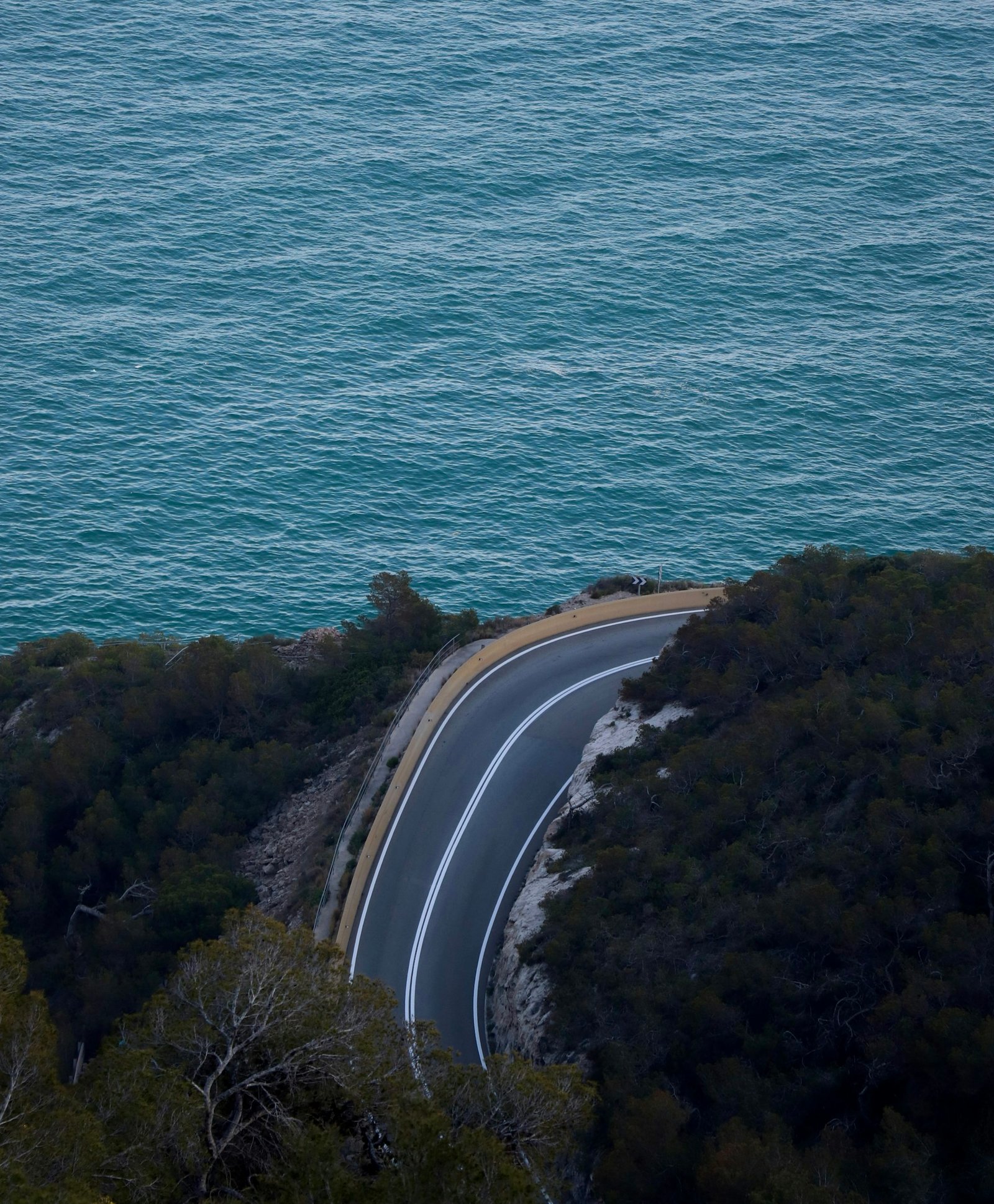 Curving road along the turquoise ocean coast